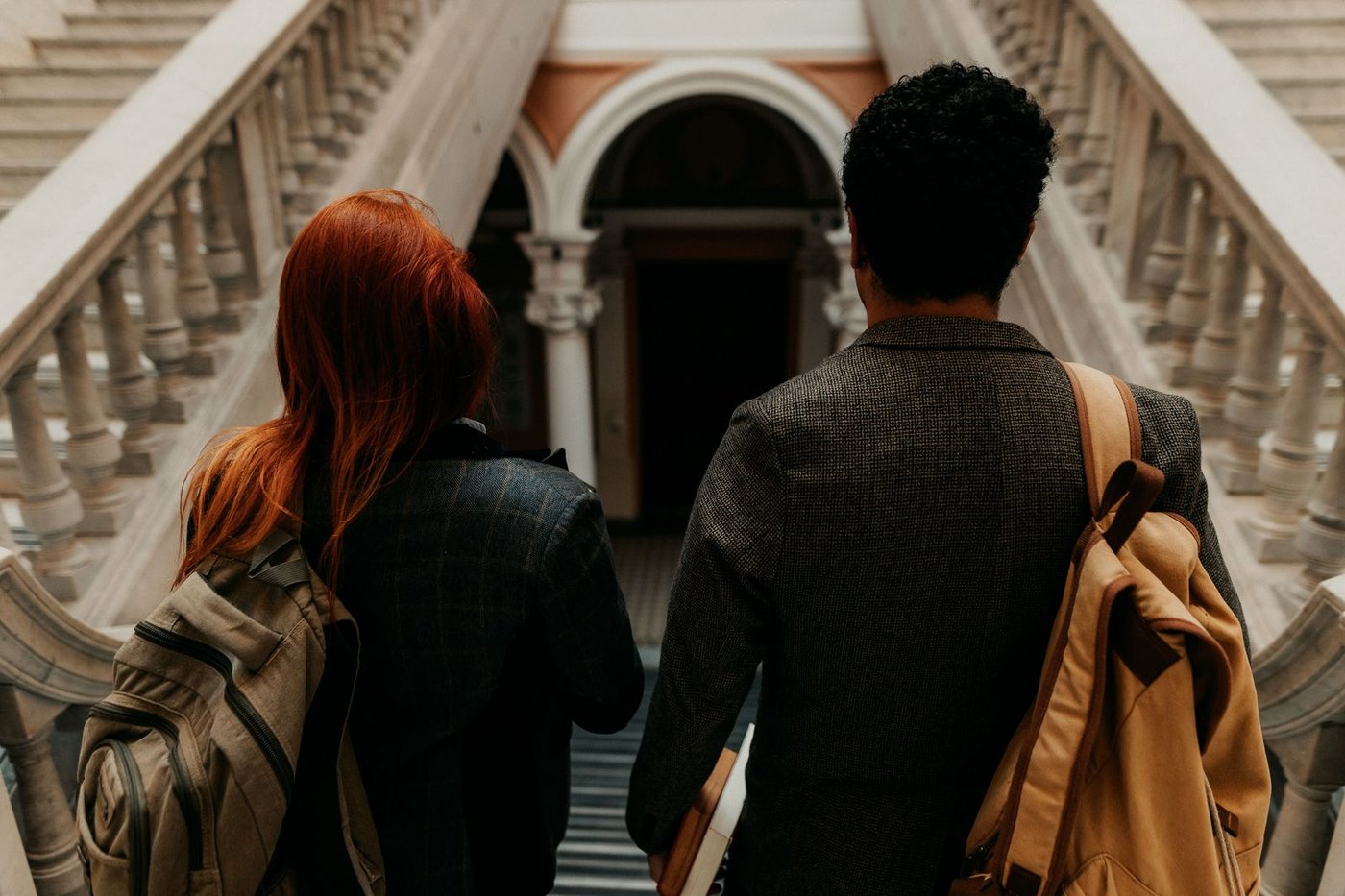 Learners in discussion on a campus walkway