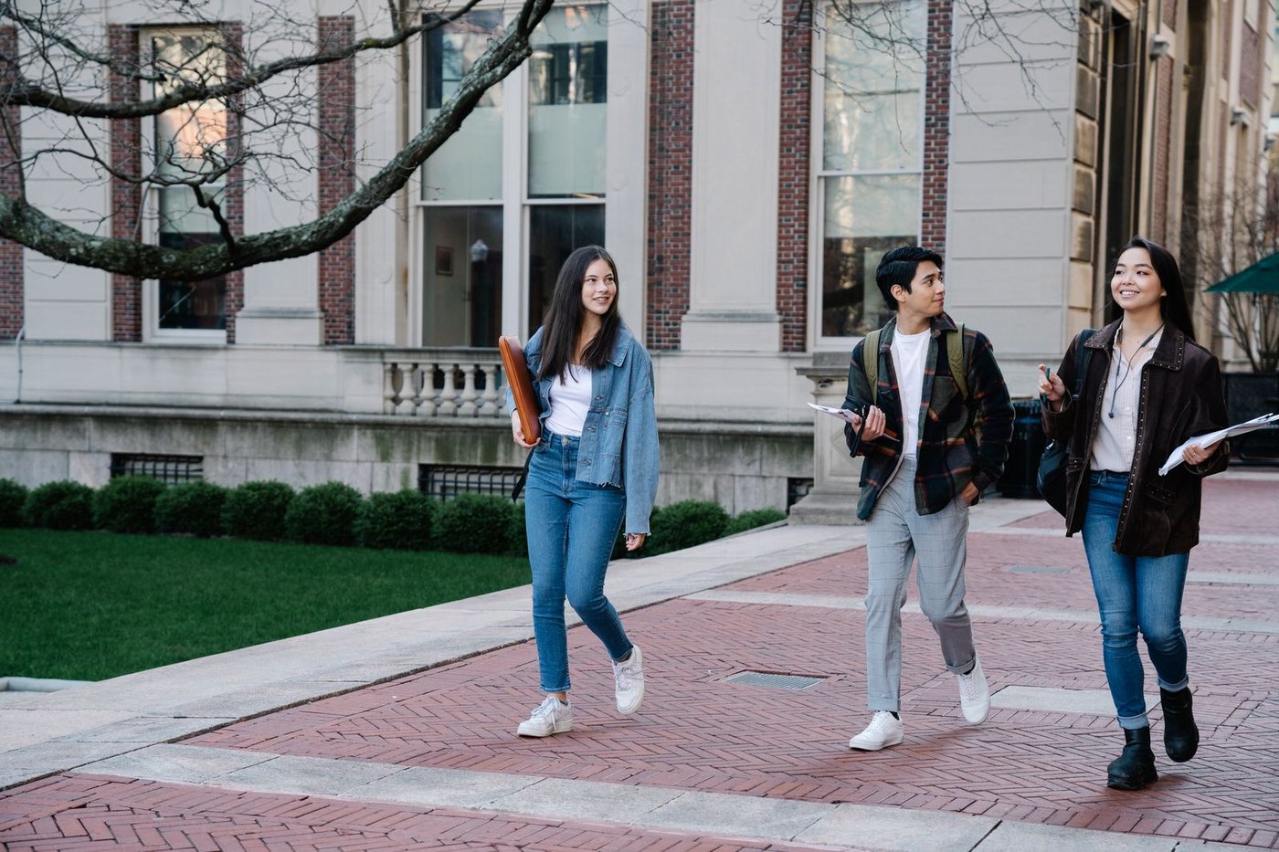 Two students walking together across a university campus