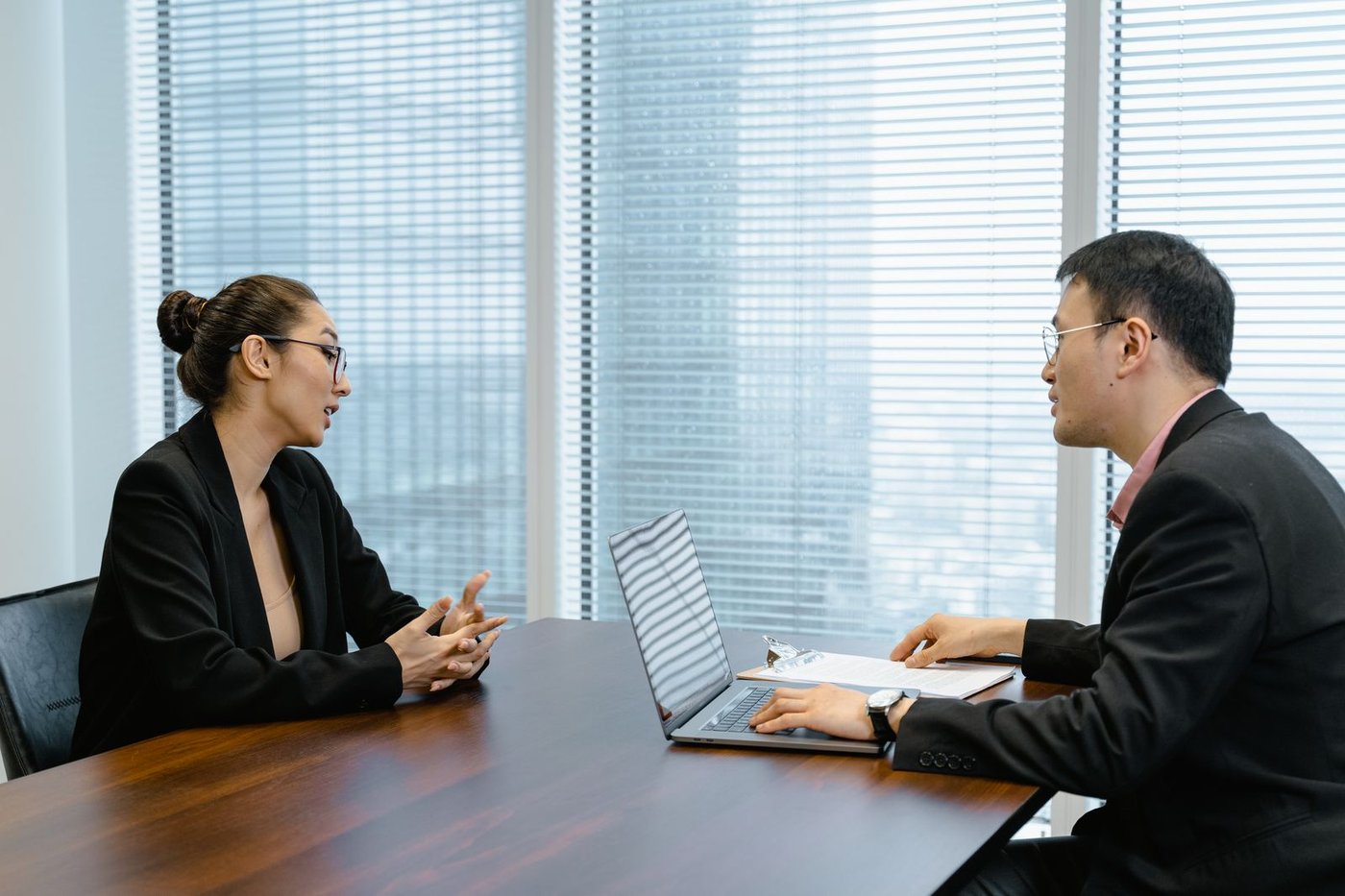 Discussion across a desk in a quiet office