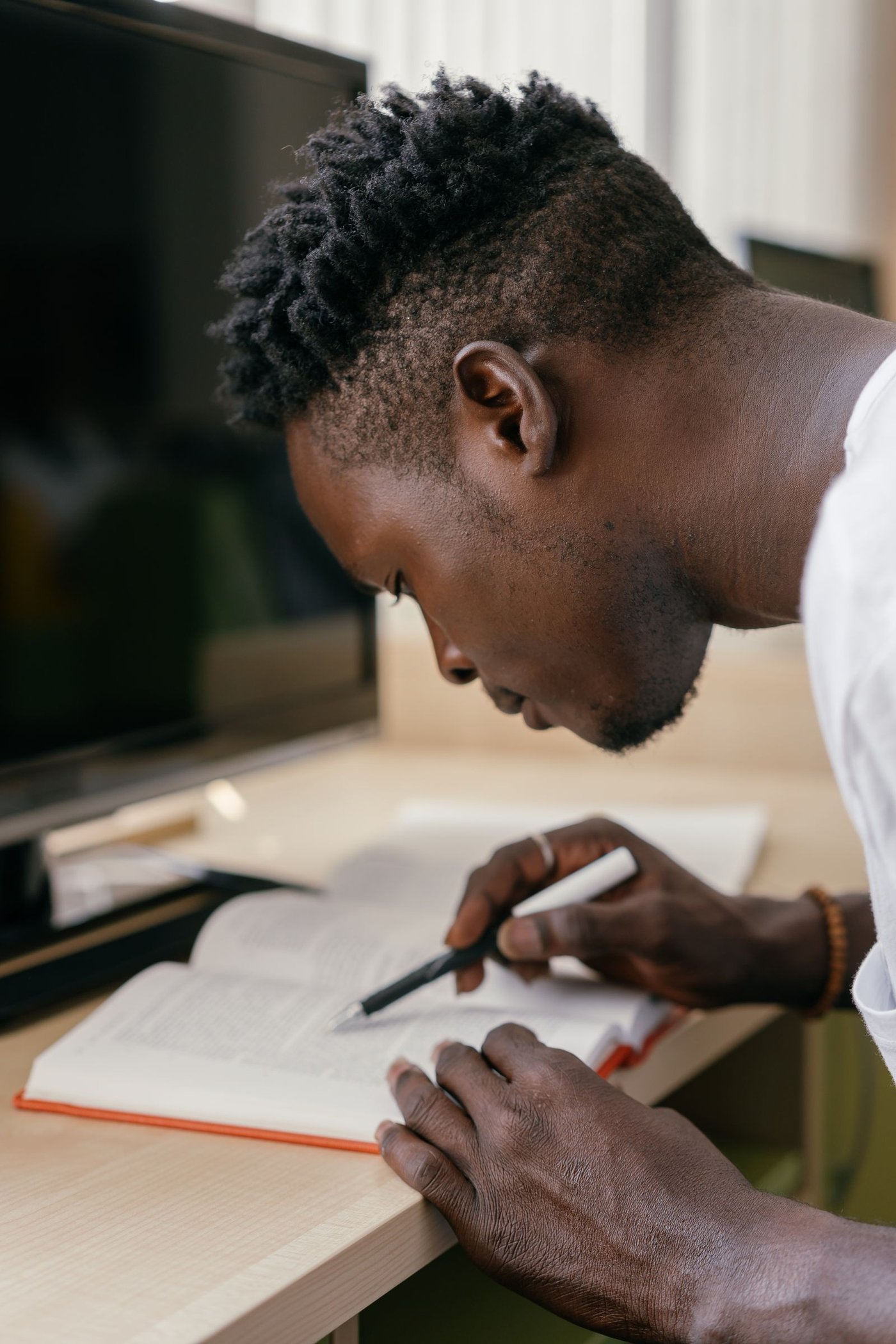Writing up notes at a desk with a laptop