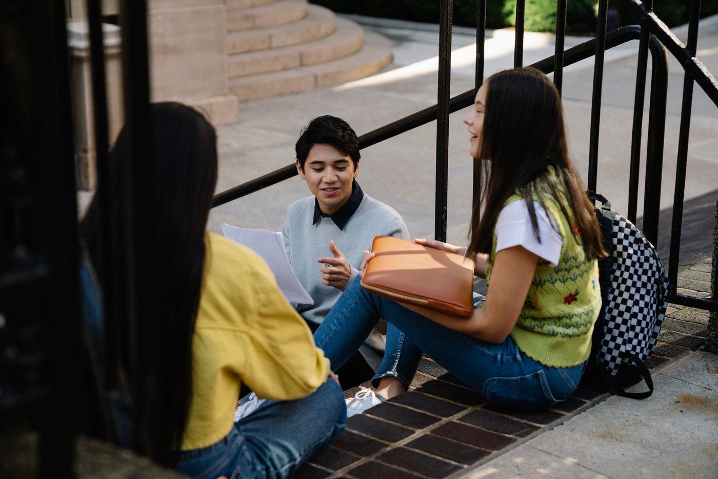A small group of students talking on campus steps
