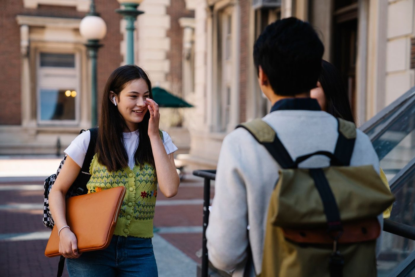 Students sitting on wide stone steps between classes