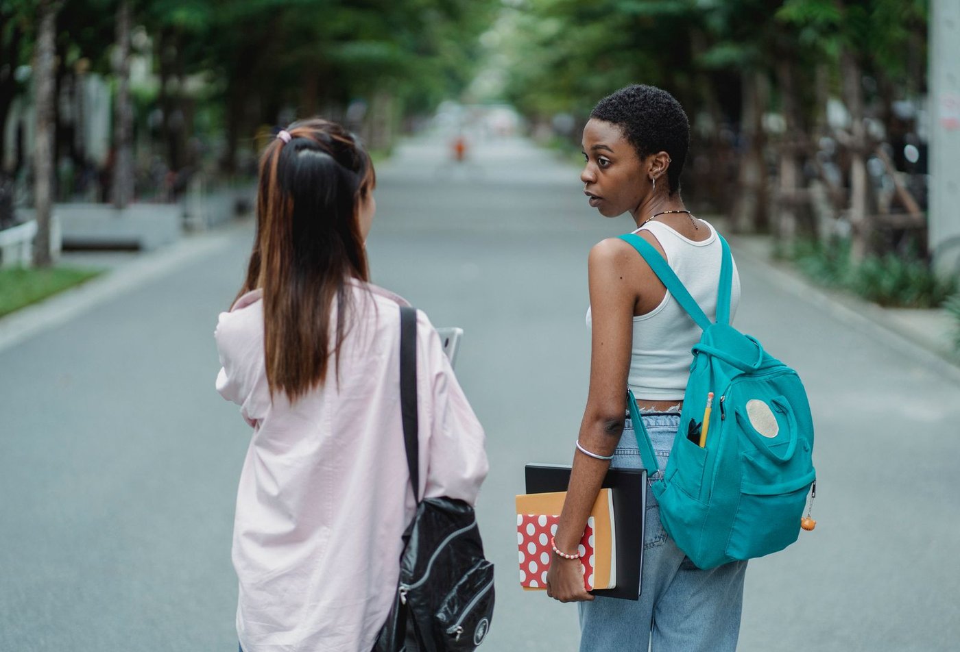 Student with a backpack on a campus walkway
